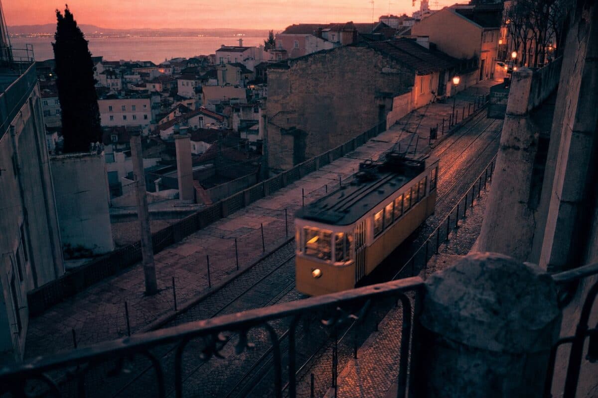 A Lisbon tram climbing a tiled street — the kind of ride you listen through